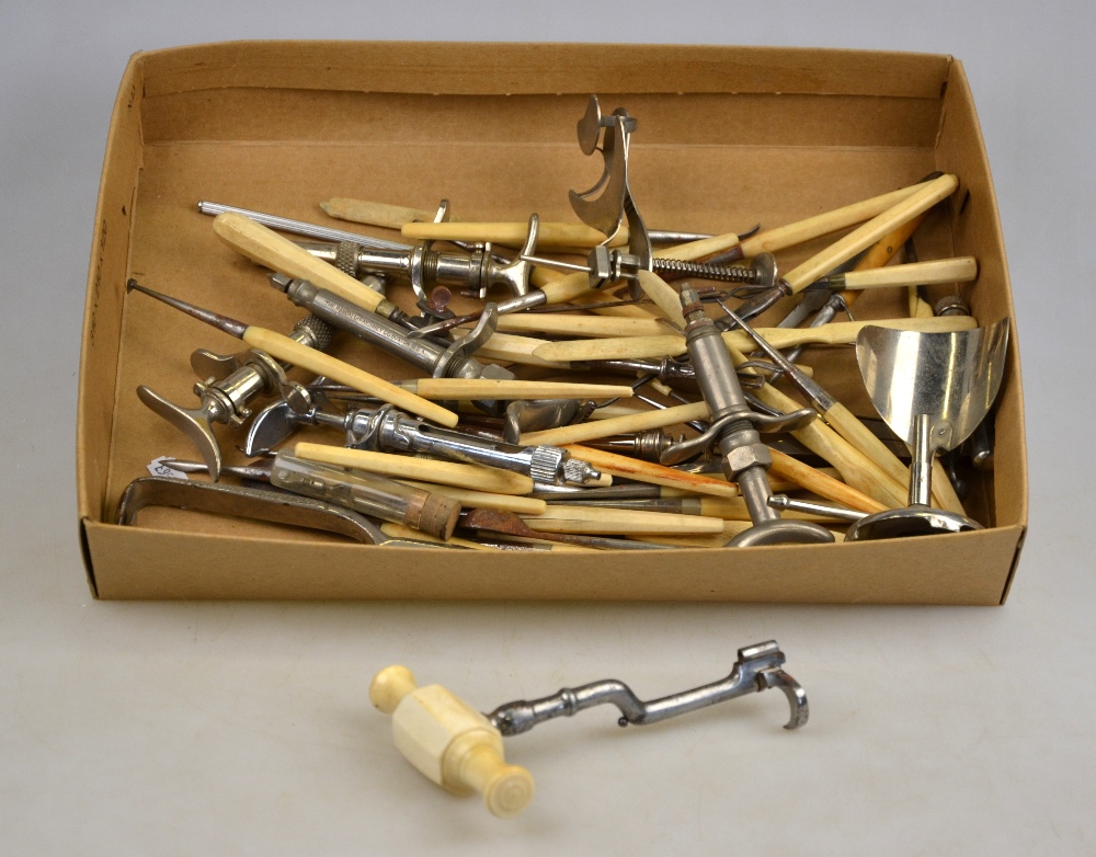A collection of antique dentist's tools, many with ivory or bone handles, including a fine French