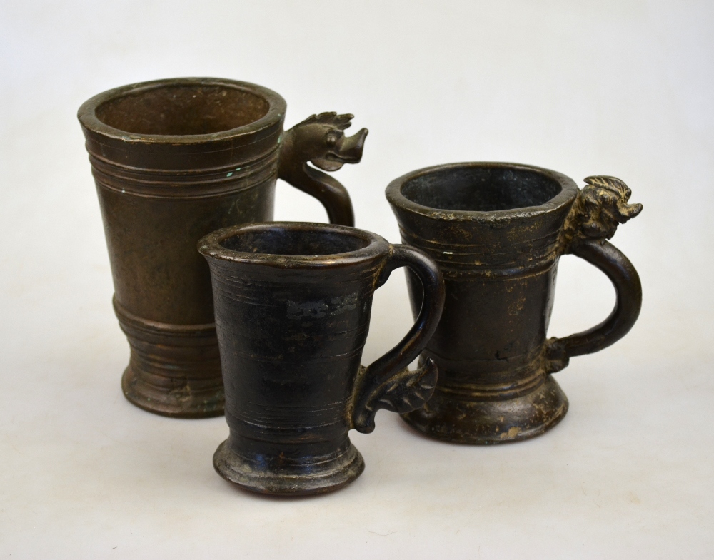 Three graduated Burmese bronze mortars, two with serpent handles, 18th/19th century (3)