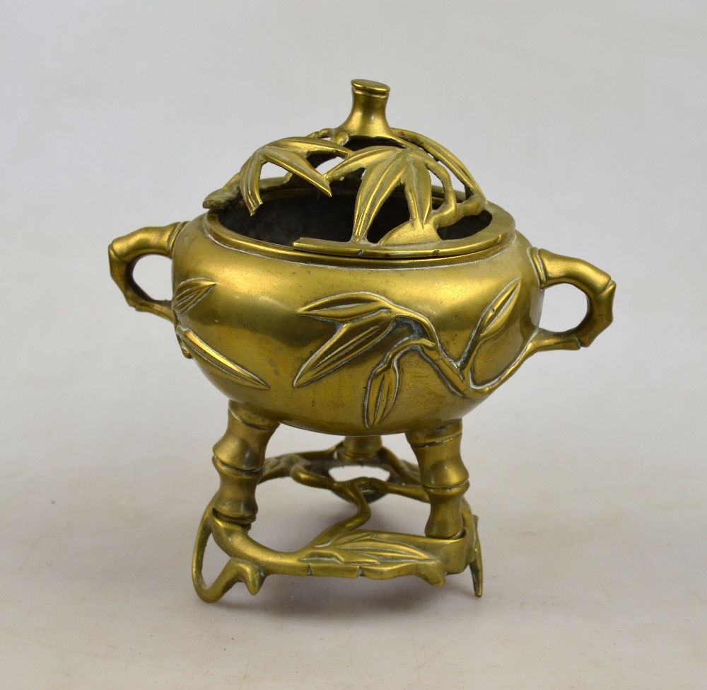 A Chinese polished bronze censer cast with faux bamboo handles and three legs, seal mark to base,