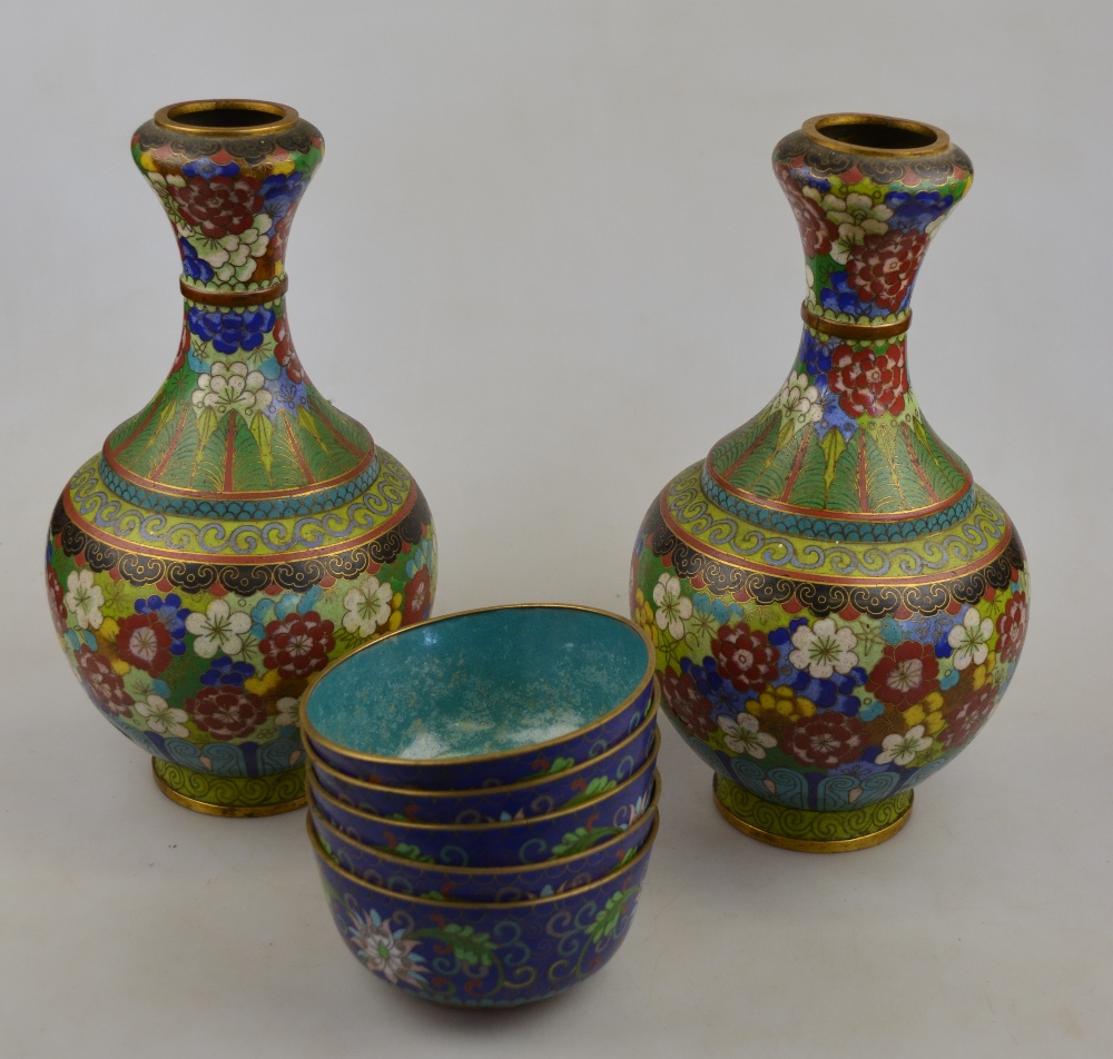 A pair of Chinese cloisonne ovoid vases with spreading necks decorated with flower heads, 26 cm,