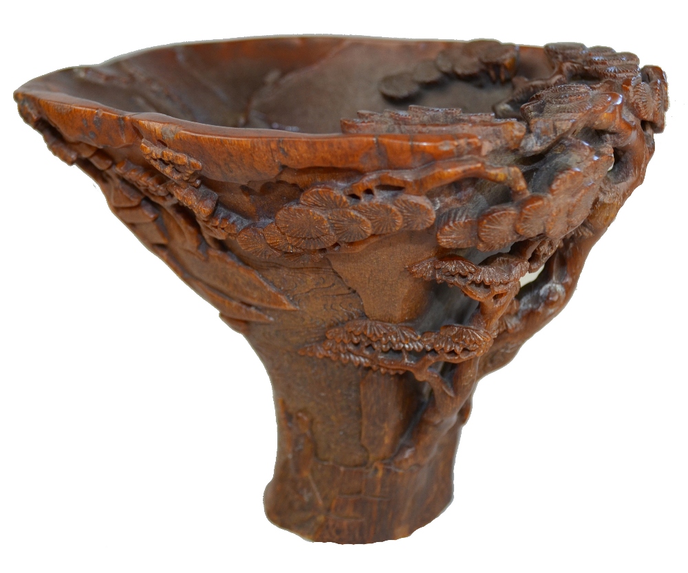 A good Chinese rhinoceros horn libation cup, Kangxi (1662-1722), finely carved around the exterior