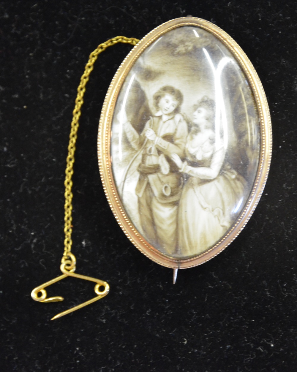 A Georgian elliptical oval mourning brooch featuring painted and hairwork scene of mother and