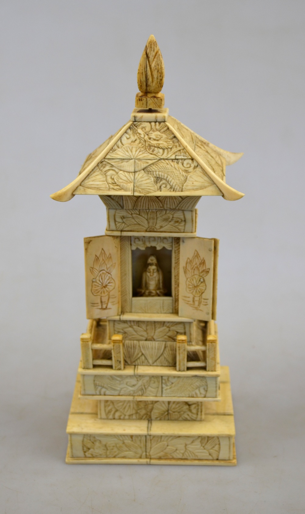 A Chinese bone table top shrine, opening to reveal a seated Buddha, 19th century, 24 cm