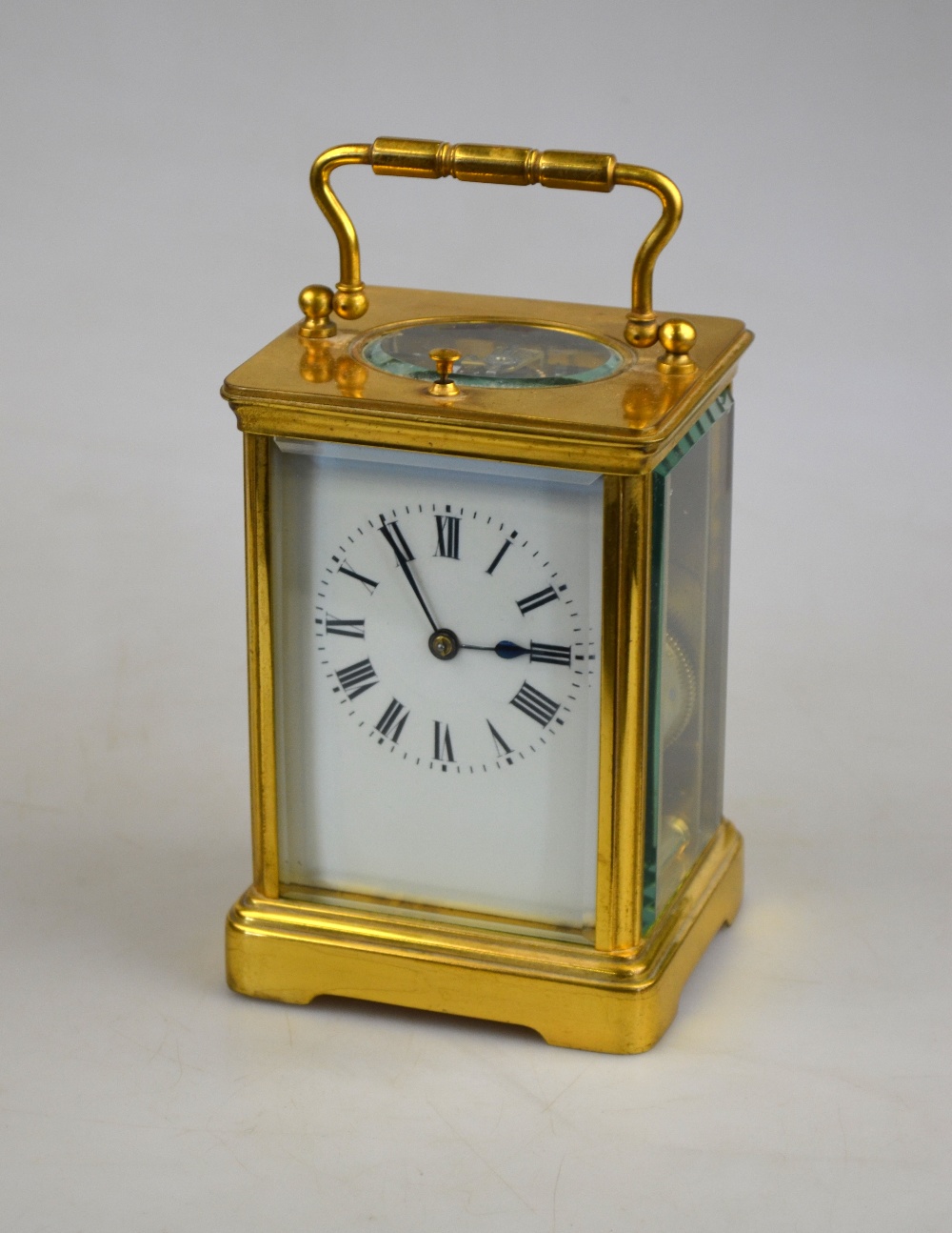 A French lacquered brass carriage clock, the eight-day movement striking the half and hours on a