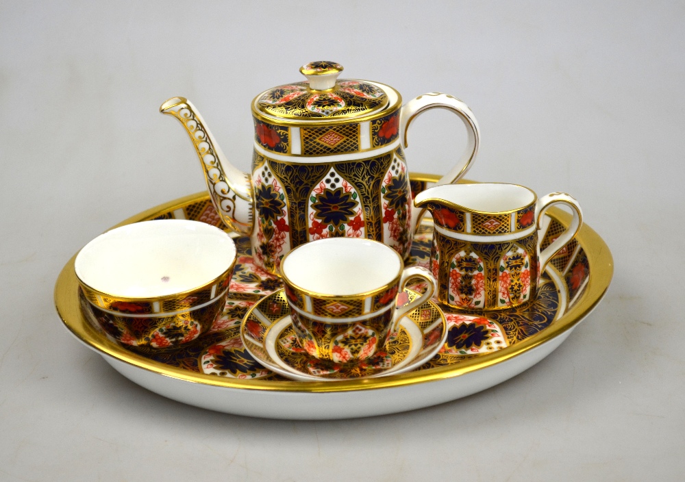 A Crown Derby Imari decorated miniature cabaret set, pattern 1128 and comprising oval tray, coffee