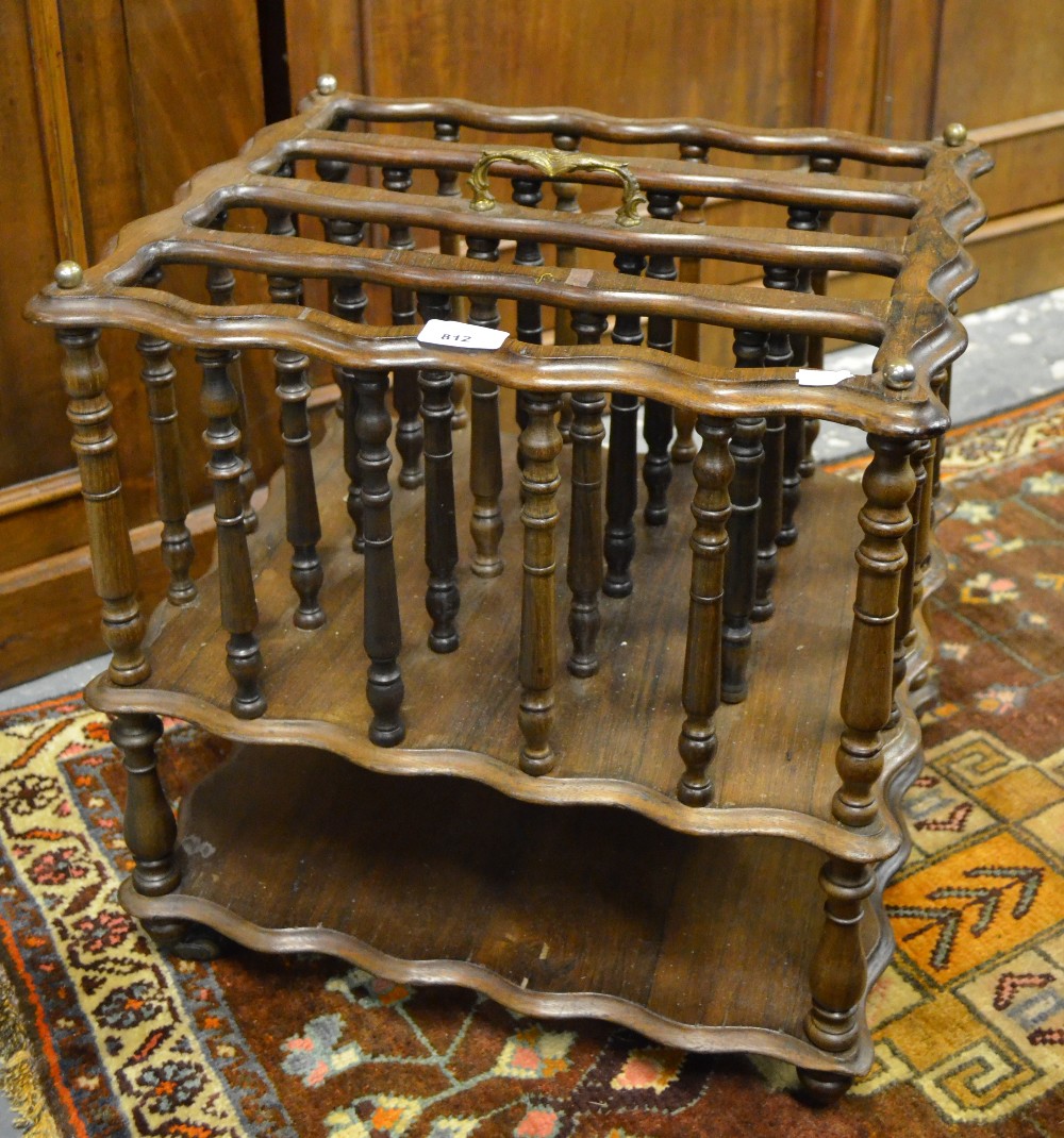 A 19th century rosewood four division Canterbury with gilt metal handle and open shelf to base,