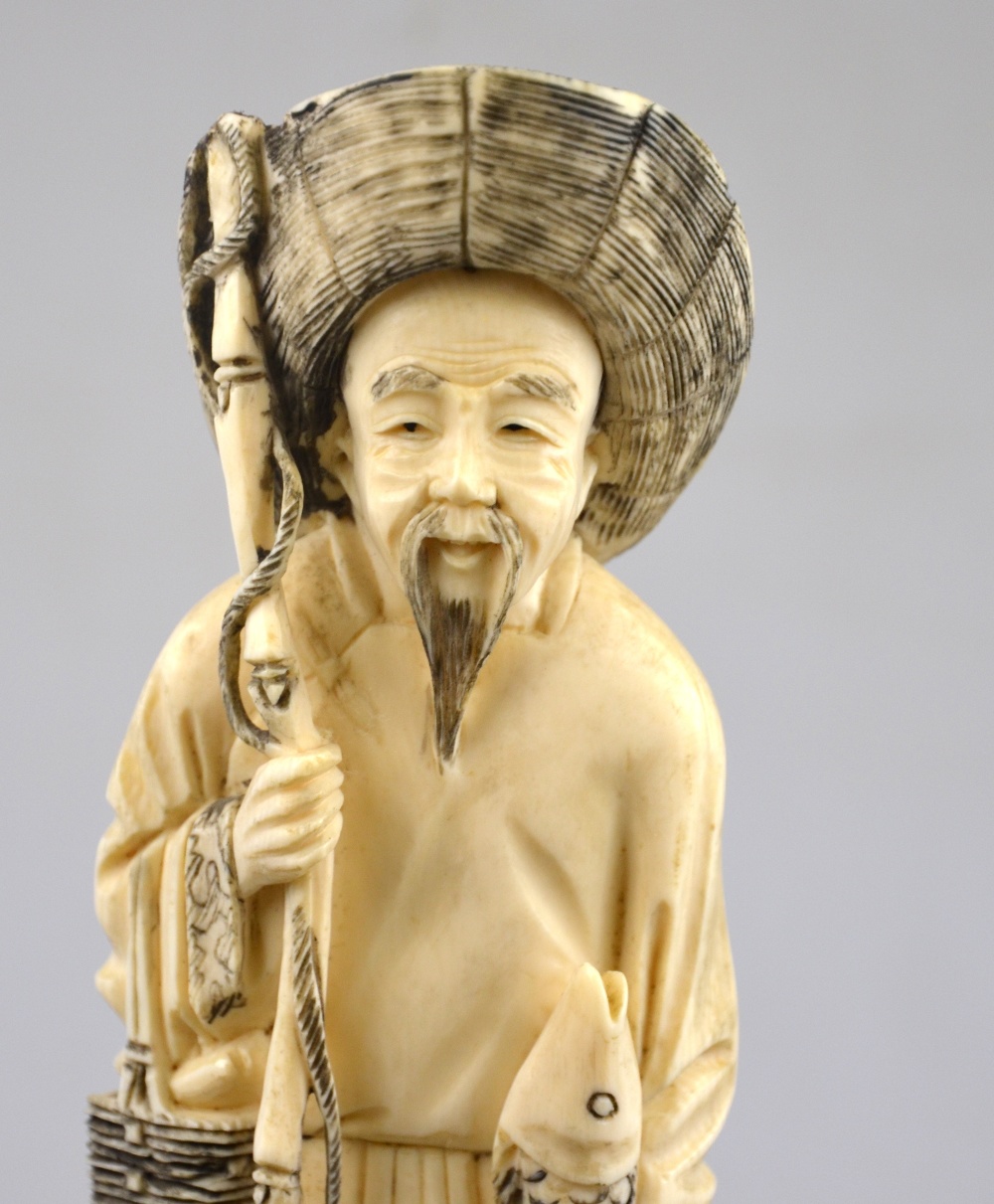 A Chinese late 19th/early 20th century ivory carving of a fisherman holding a fishing line in one - Image 4 of 4