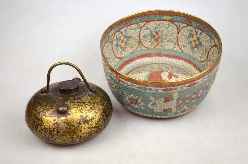 A Chinese bronze compressed globular pot with screw top and swing handle decorated with gilt flowers