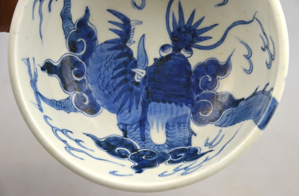 A Chinese 19th century heavily potted porcelain blue and white bowl decorated with a dragon - Image 2 of 5