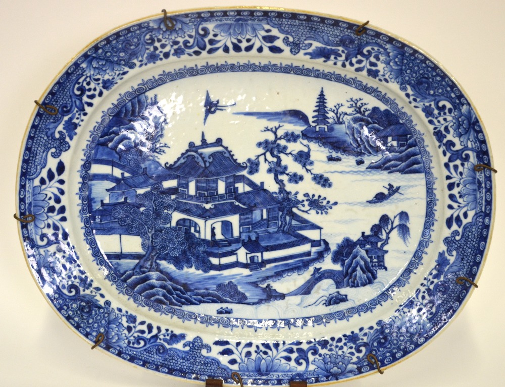 A Chinese 18th century blue and white oval porcelain serving dish decorated with a pagoda in a