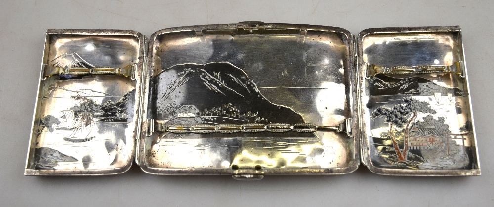 A Japanese mixed metal and silver cigarette case decorated with a watery landscape with Mount Fuji - Image 3 of 3