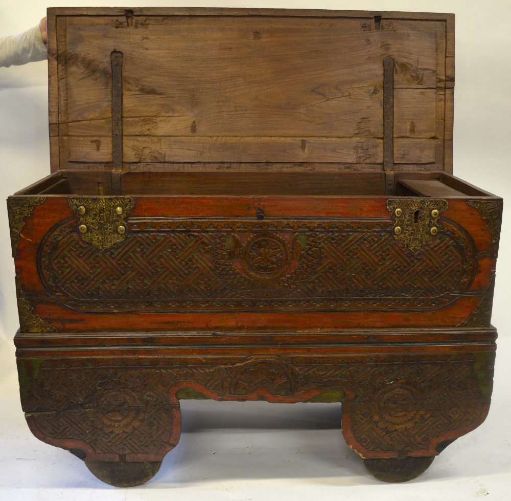 A large carved teak trunk on trolley wheels, traces of original polychrome decoration, 101 cm high x - Image 2 of 2