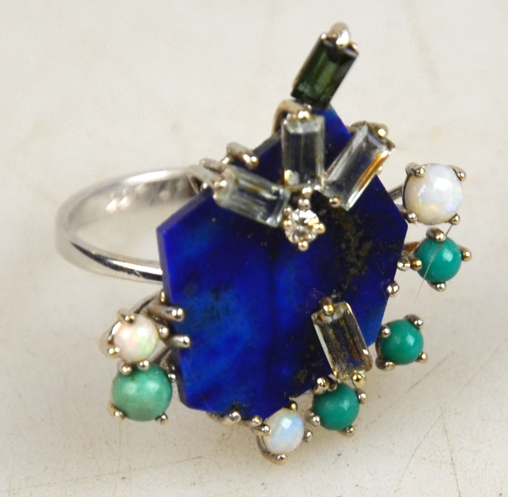 A contemporary style ring set with lapis lazuli, four baguette diamonds, tourmaline, opal and