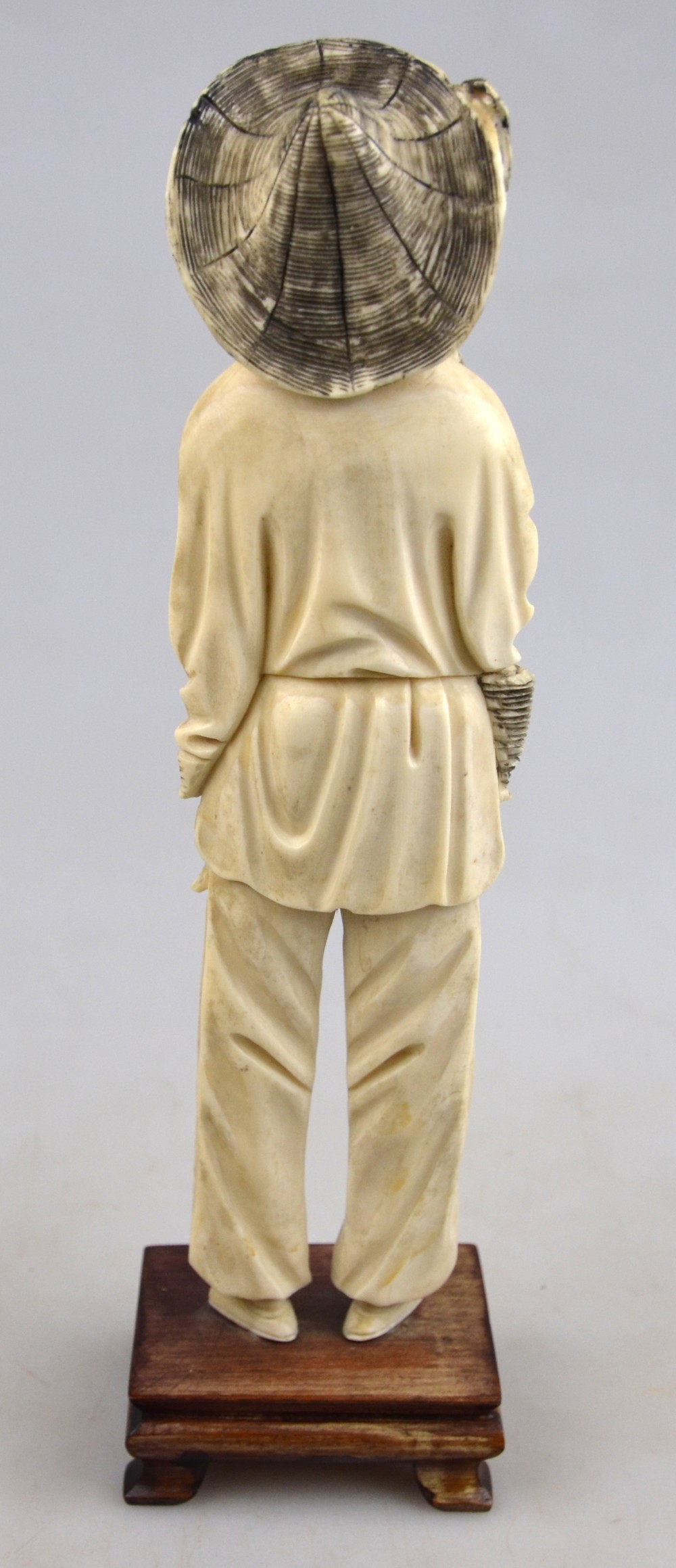 A Chinese late 19th/early 20th century ivory carving of a fisherman holding a fishing line in one - Image 3 of 4