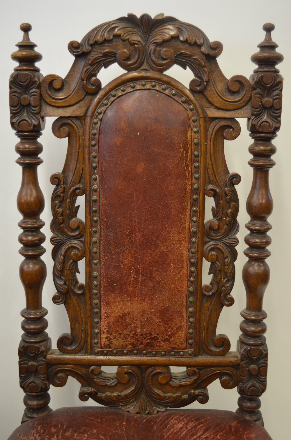 A pair of 19th century continental carved oak hall chairs with original battered red leather - Image 2 of 2