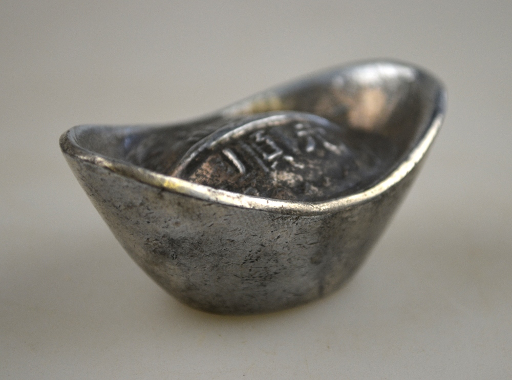 A Chinese silver boat shaped sycee bearing a four character mark, 114.6 grms