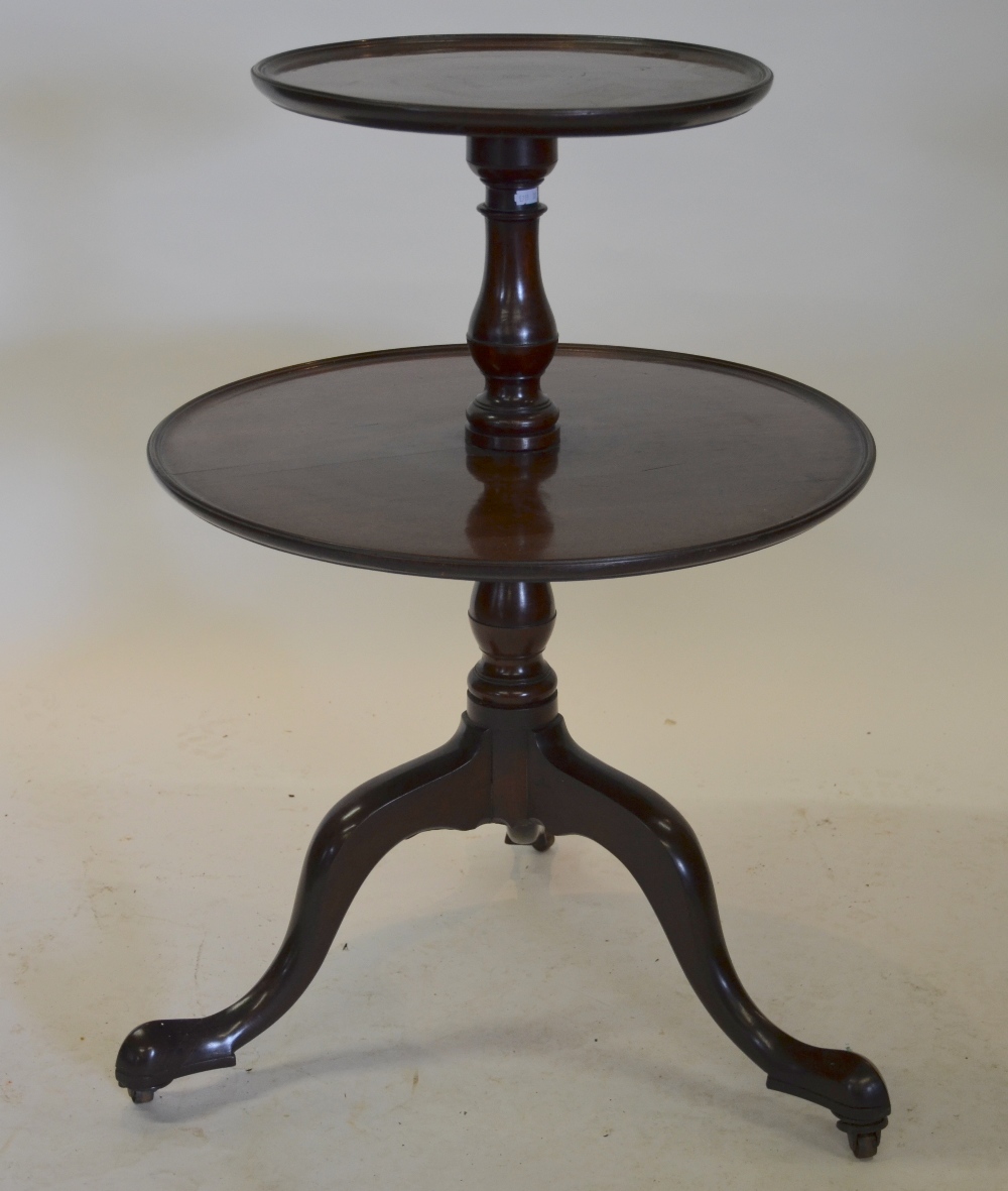 A Victorian two tier dumb waiter, the circular graduated tiers raised on a tripod base, 85 cm high x