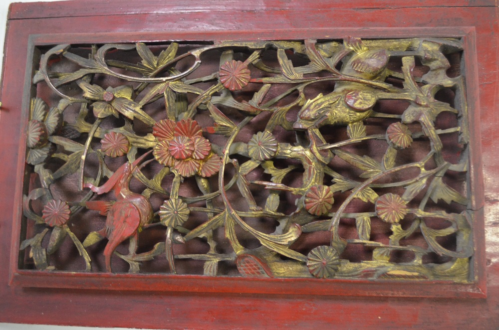 A pair of Chinese reticulated panels carved with trees, flowers, birds and fabulous animals,