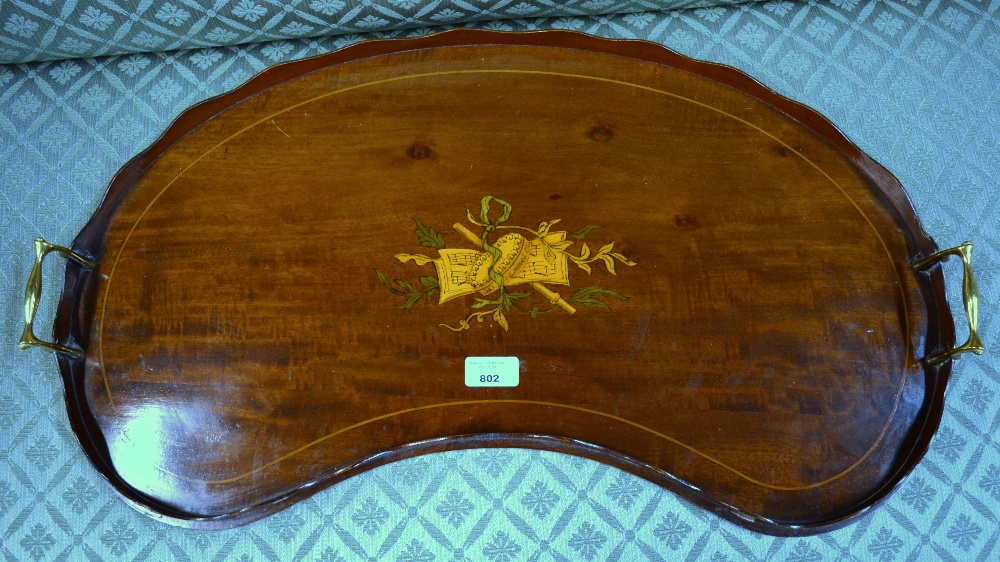 An Edwardian inlaid satin walnut kidney shaped tray with wavy gallery and brass handles