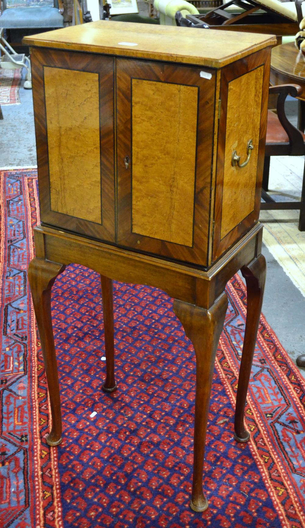 A 19th century crossbanded pollard oak table cabinet, the pair of doors enclosing five graduated