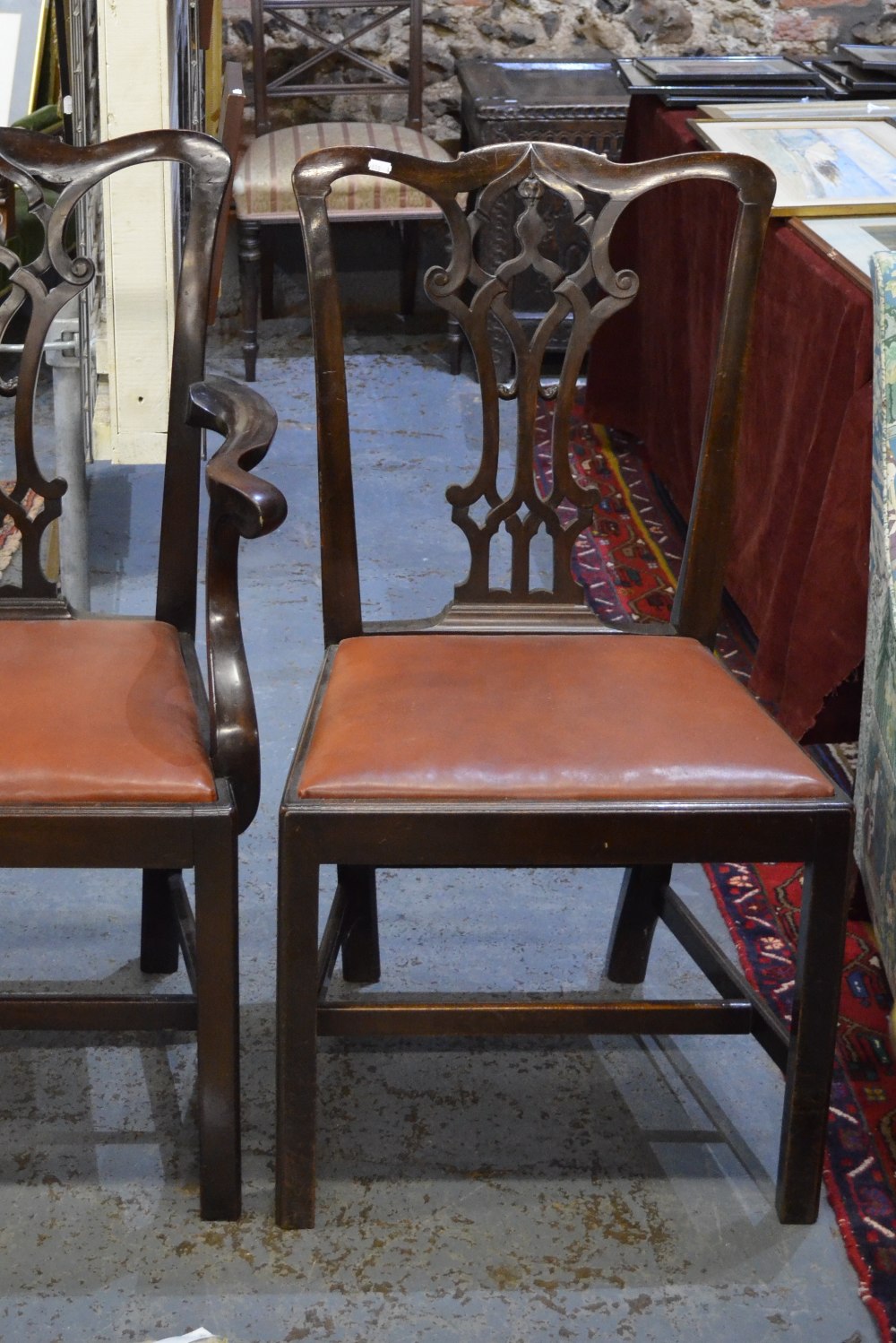 A set of eight Chippendale style mahogany dining chairs with shaped, pierced, vertical splats over