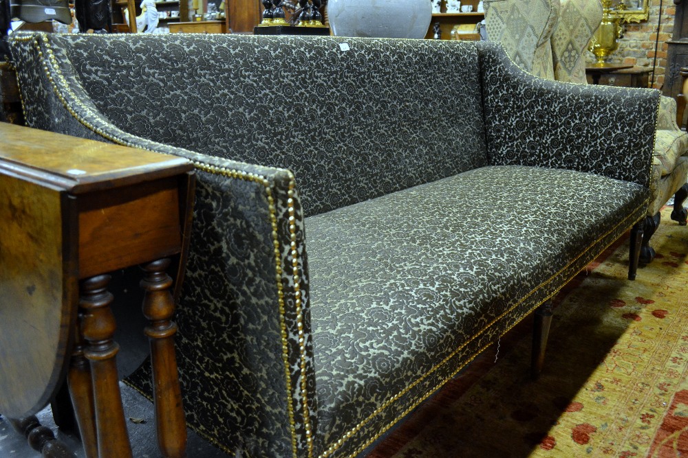 A 19th century brass studded fabric upholstered sofa, the straight back to downswept arms raised