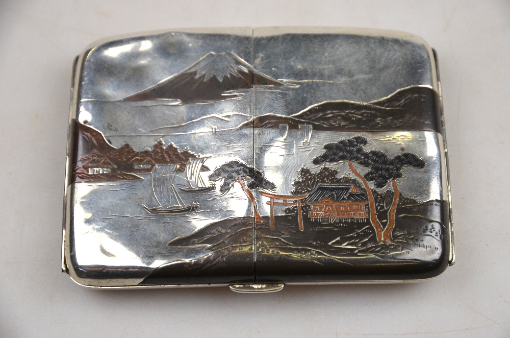 A Japanese mixed metal and silver cigarette case decorated with a watery landscape with Mount Fuji