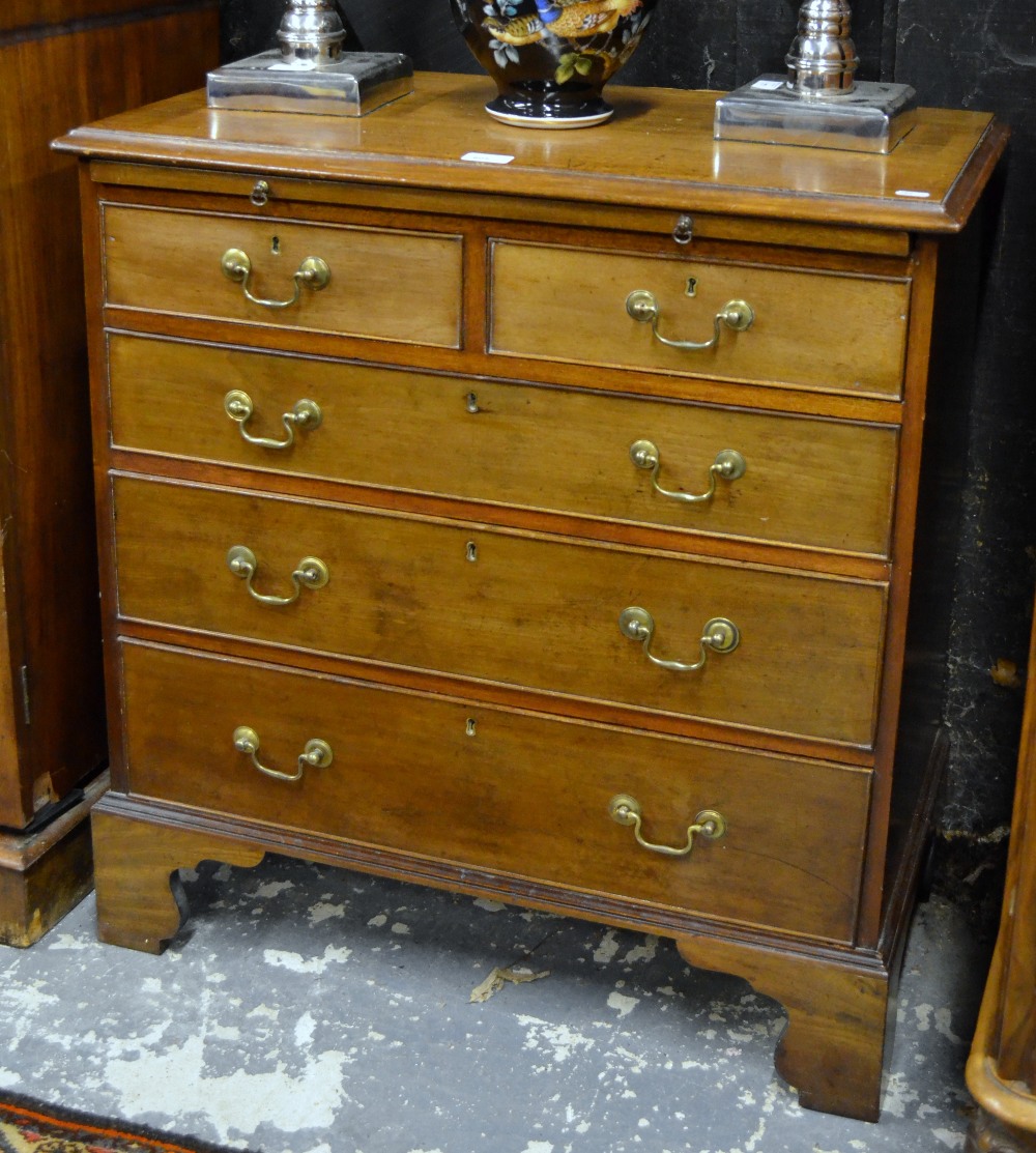 A diminutive Georgian styled mahogany chest of two short and three long graduated cockbeaded drawers