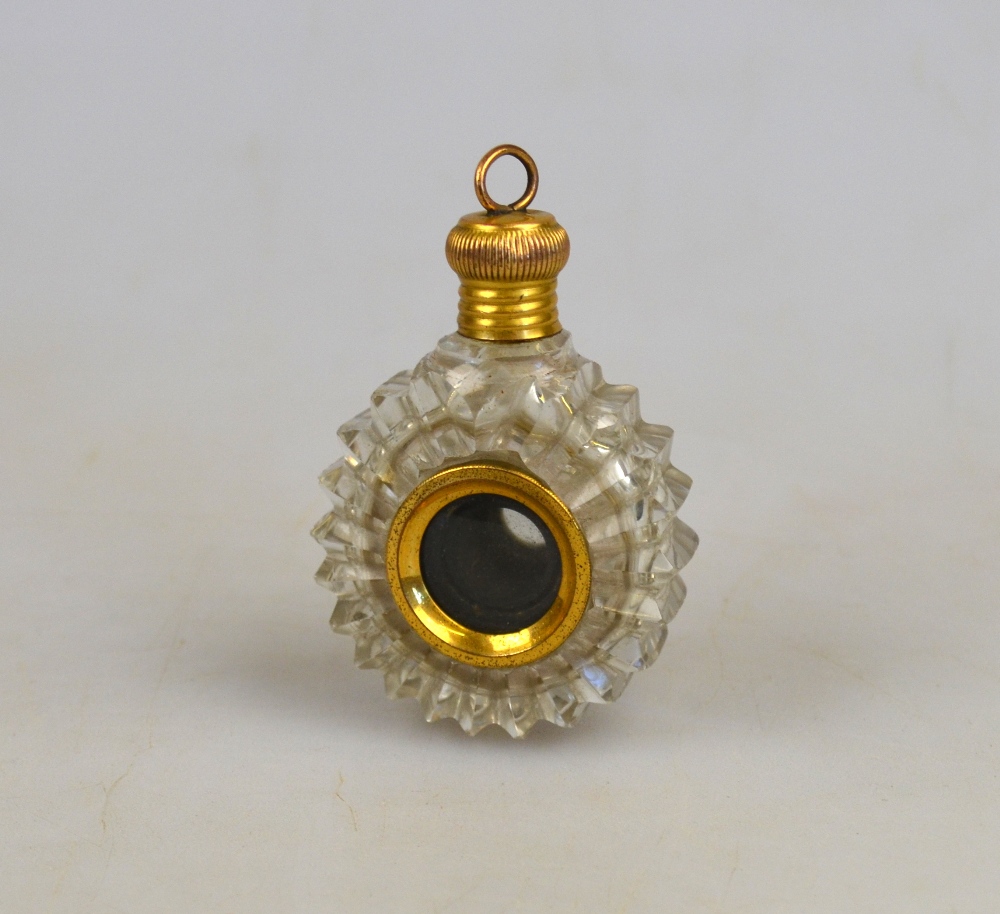 A 19th century cut glass novelty scent bottle/spy glass of circular form with gilt metal cover,