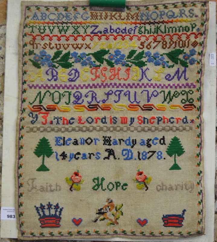 A Victorian needlework sampler worked with alphabet, numerals and floral and foliate motifs, by
