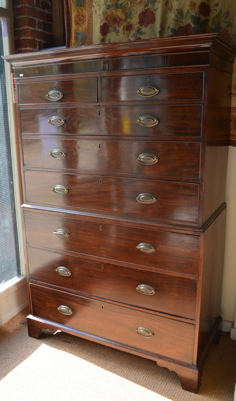 A George III mahogany tallboy having two short over six long graduated cock-beaded drawers, raised