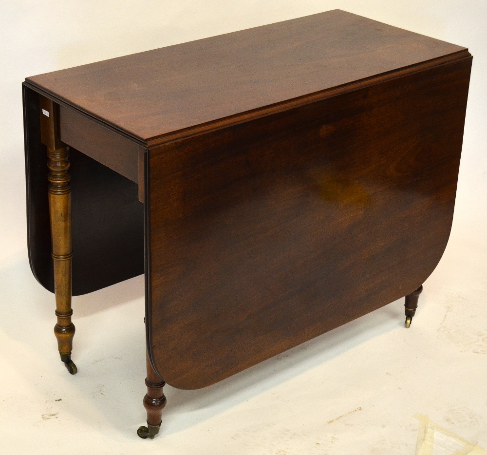 A 19th century mahogany drop leaf supper table, raised on slender turned legs on brass castors, 92