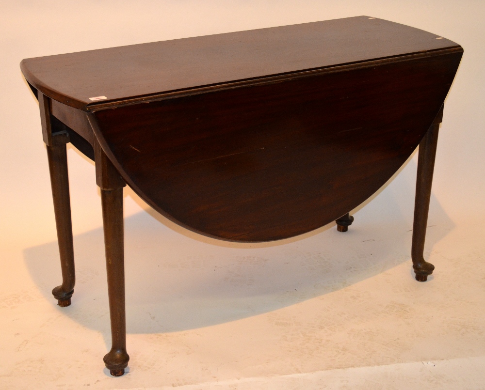 A George III mahogany drop leaf table, the oval top raised on turned pad foot supports, 122 cm x 75