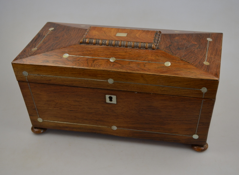 A Victorian mother-of-pearl inlaid rosewood tea caddy of sarcophagus form, the interior with two