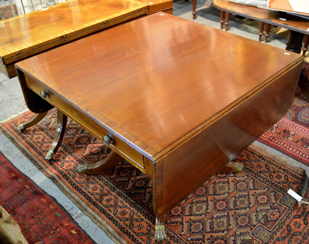 Victorian mahogany drop leaf centre table, raised on a quad base on brass pew caps and castors