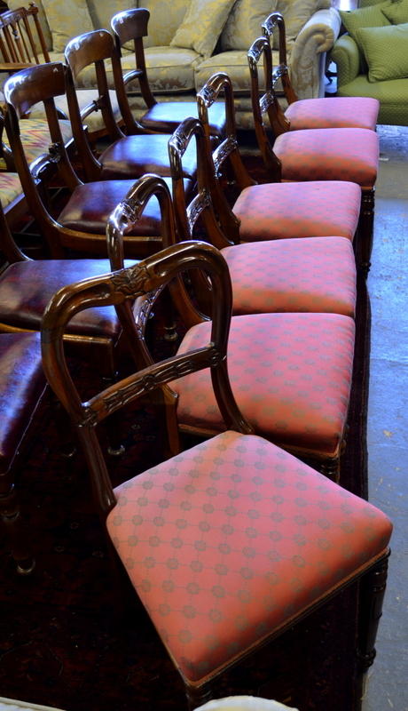 A set of six Victorian rosewood side chairs having carved horizontal splats over overstuffed seats