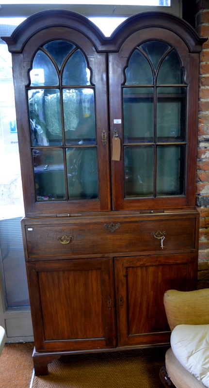 A George III mahogany secretaire bookcase, the double domed top over a pair of multi glazed doors