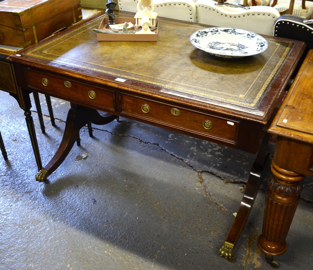 A mahogany library table, the rectangular top with inset tooled green leather surface over two