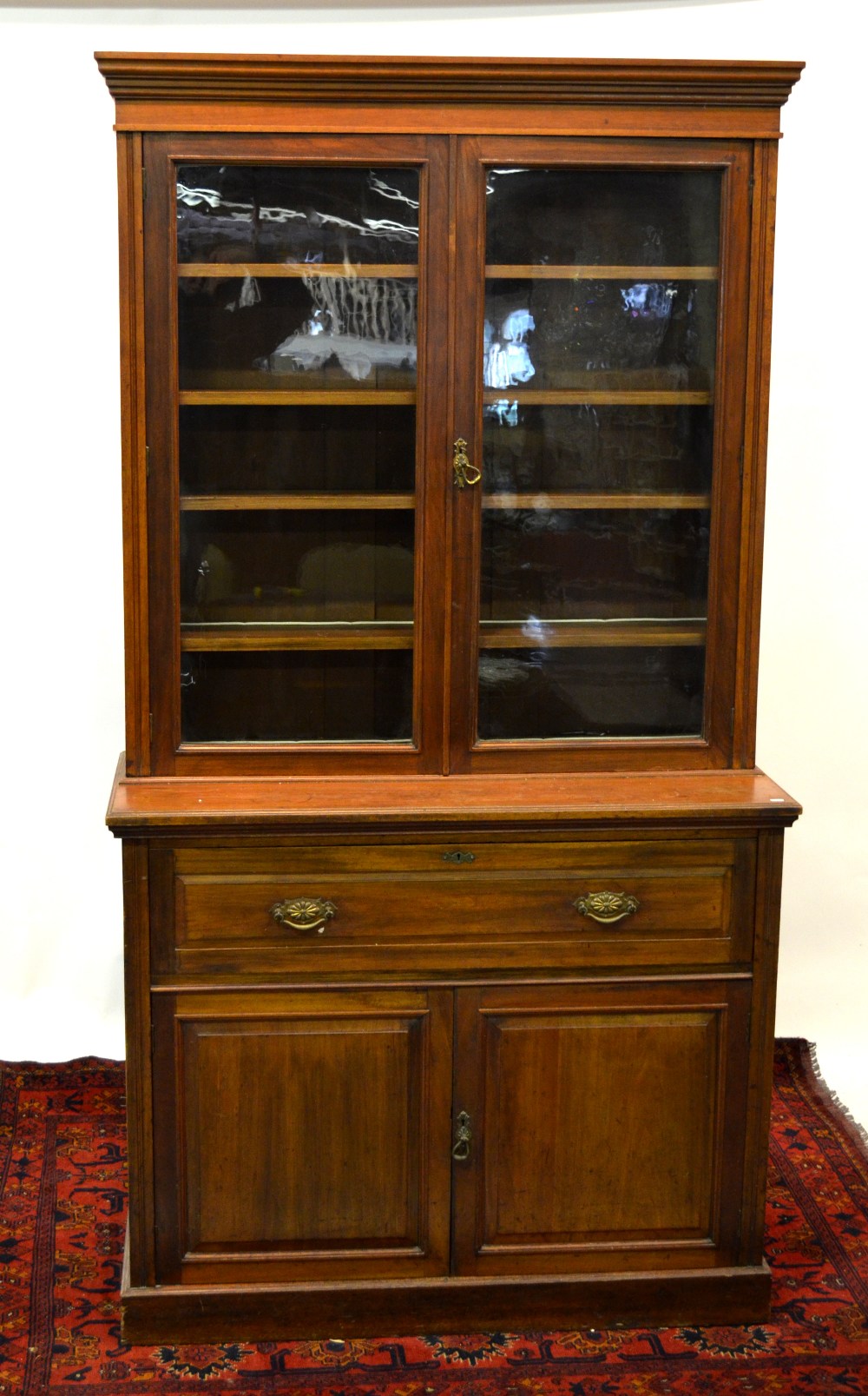 A late 19th century mahogany secretaire bookcase, the pair of glazed doors over a fitted drawer and