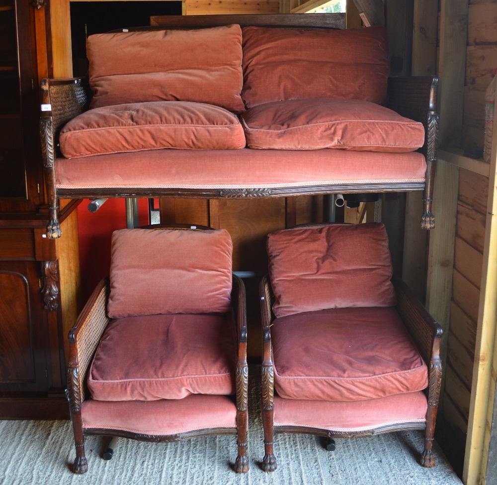 A vintage mahogany framed bergere suite, comprising a two seat sofa and pair of armchairs, each