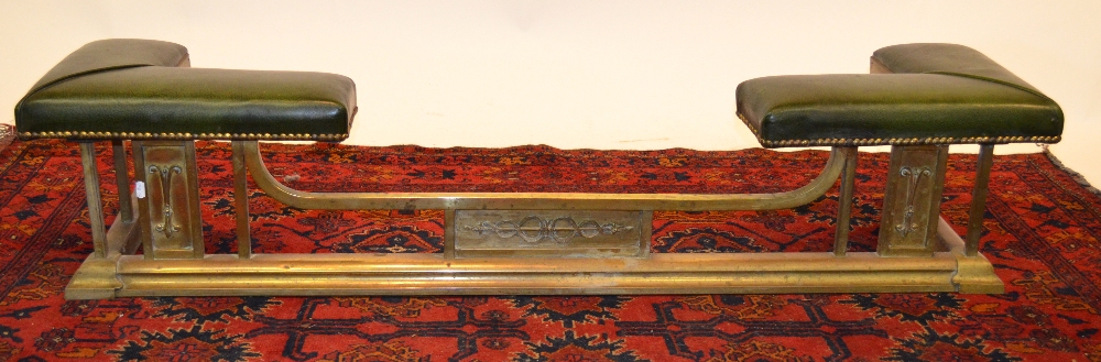 An antique brass low club fender with green studded leather corners, 144 cm long x 29 cm high x 36