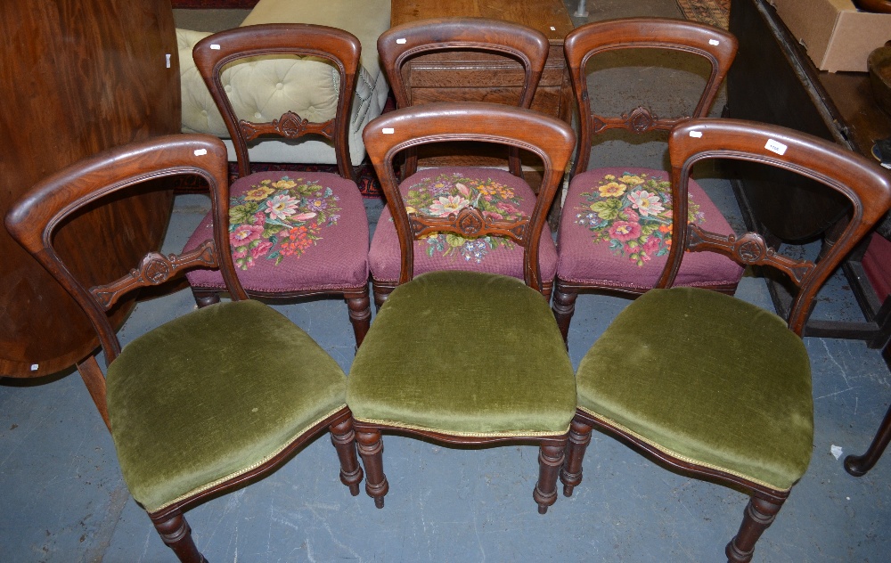 A set of six Victorian mahogany side chairs with overstuffed serpentine seats on turned front