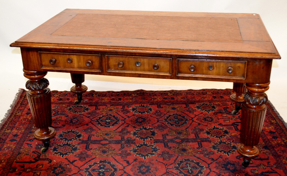 A 19th century mahogany library table, rectangular top with inset leatherette surface, over three