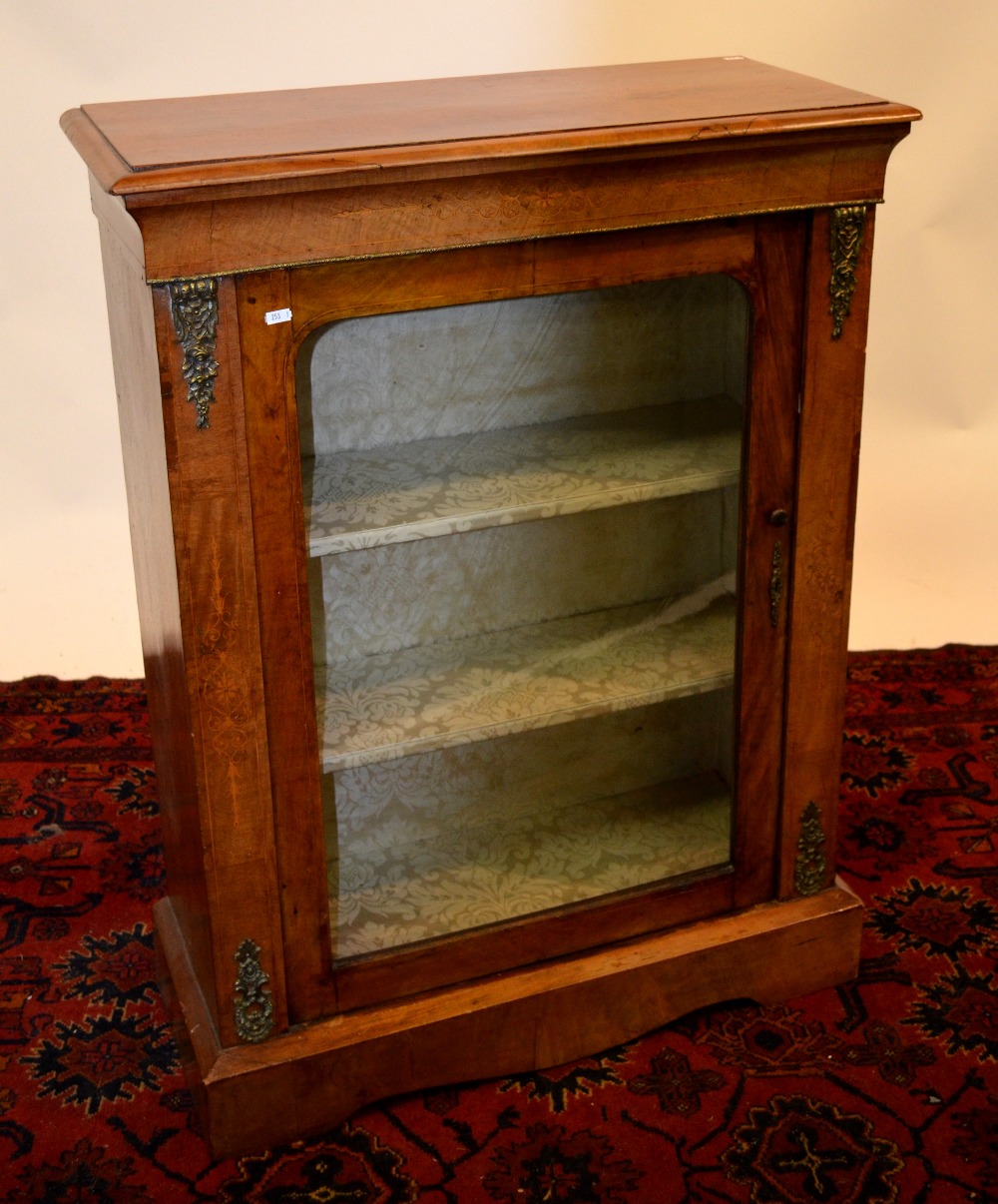 Victorian ormolu mounted inlaid walnut pier cabinet, the single glazed door enclosing a fabric