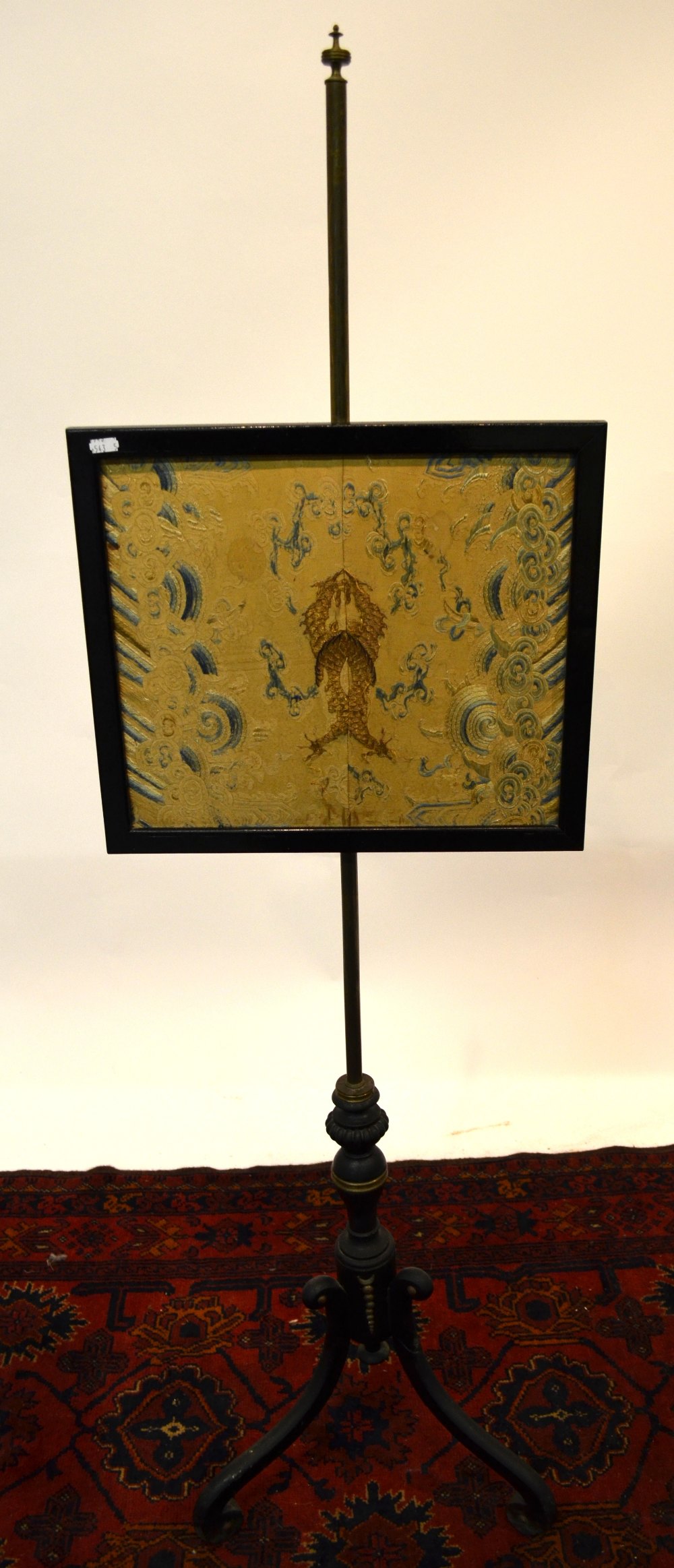 A 19th century ebonised tripod pole screen having a Chinese silk rise and fall panel