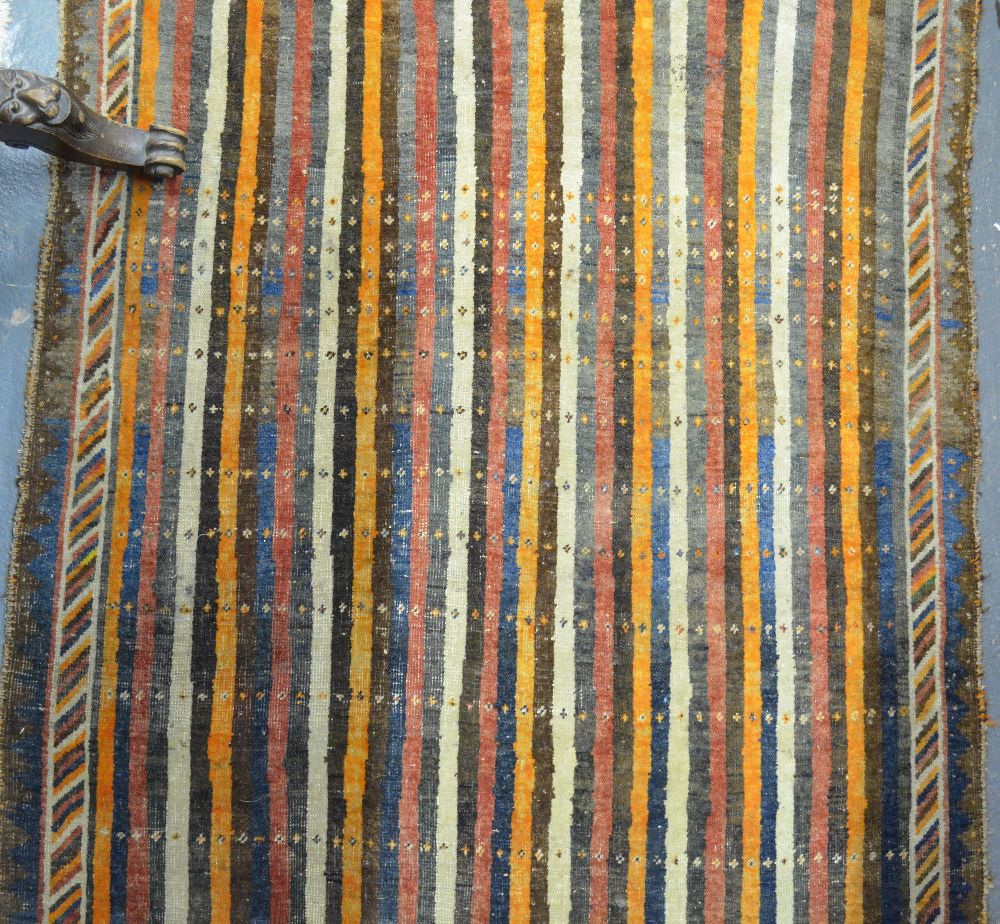 An old Persian Shiraz rug, the unusual field of multi-coloured stripes, 200 x 130 cm Condition