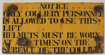 A yellow painted metal sign stencil written "Notice - Only colliery personnel is allowed to use this