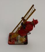 A Marx toys climbing fireman tin plate toy together with other tinplate toys, toy guns etc