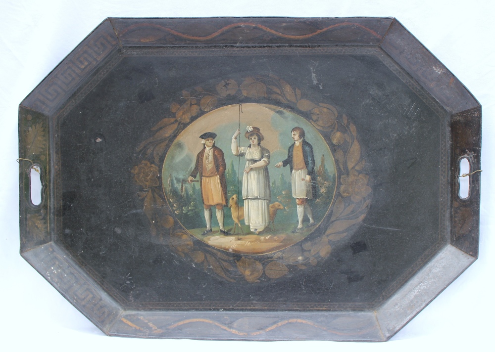 A 19th century tole ware japanned tin twin handled tray of octagonal form, painted to the centre