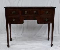 A 19th century mahogany sideboard the bowed top above five drawers on square legs and spade feet,